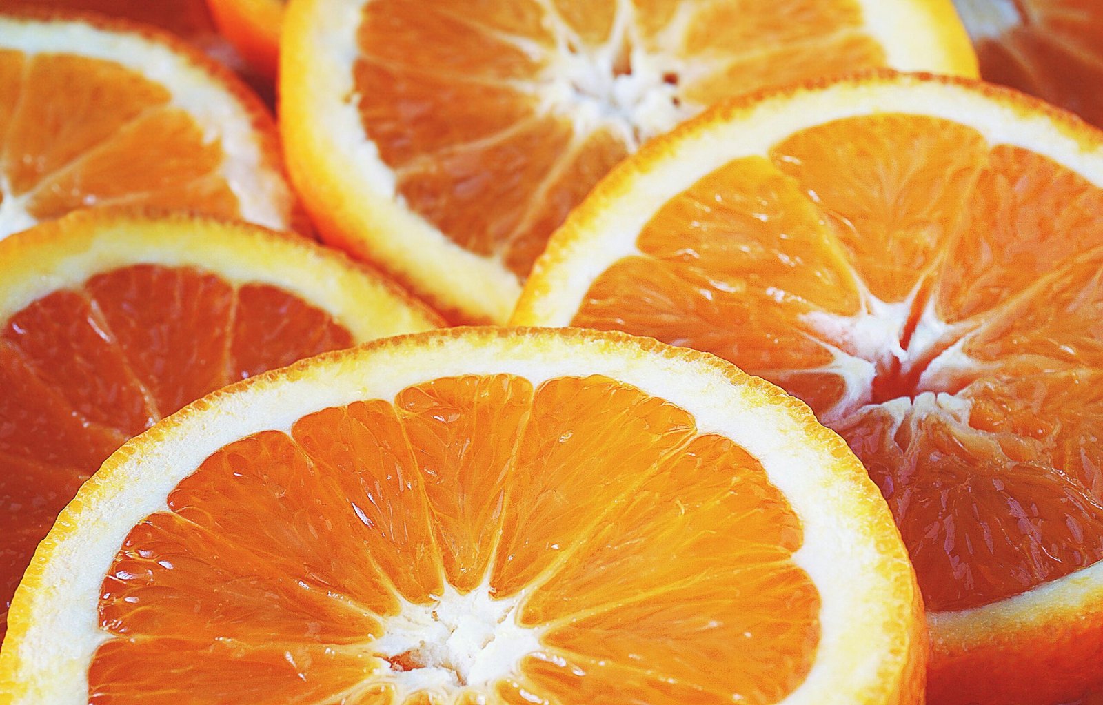 Vivid close-up of freshly sliced oranges showcasing vibrant colors and freshness.